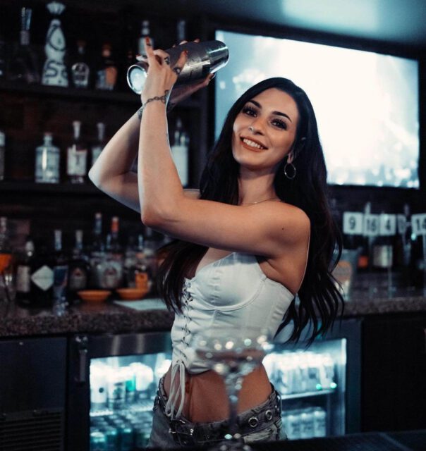 cocktail waitress shaking a cocktail
